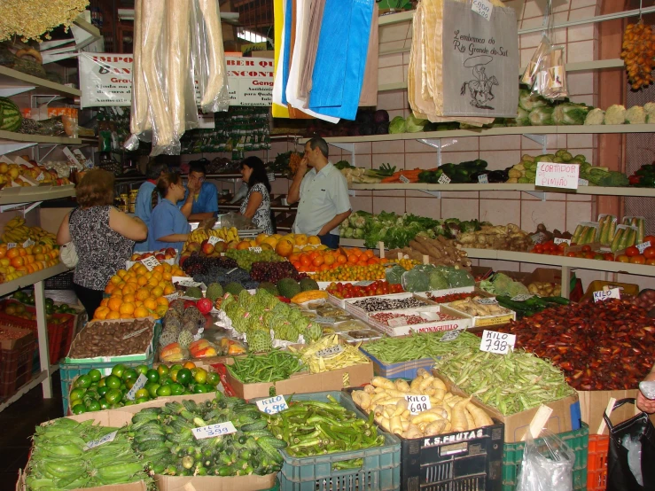 an outdoor farmers market with produce and people