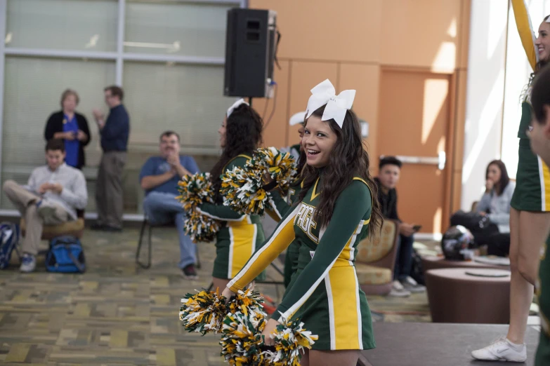 the cheerleaders are watching their team perform