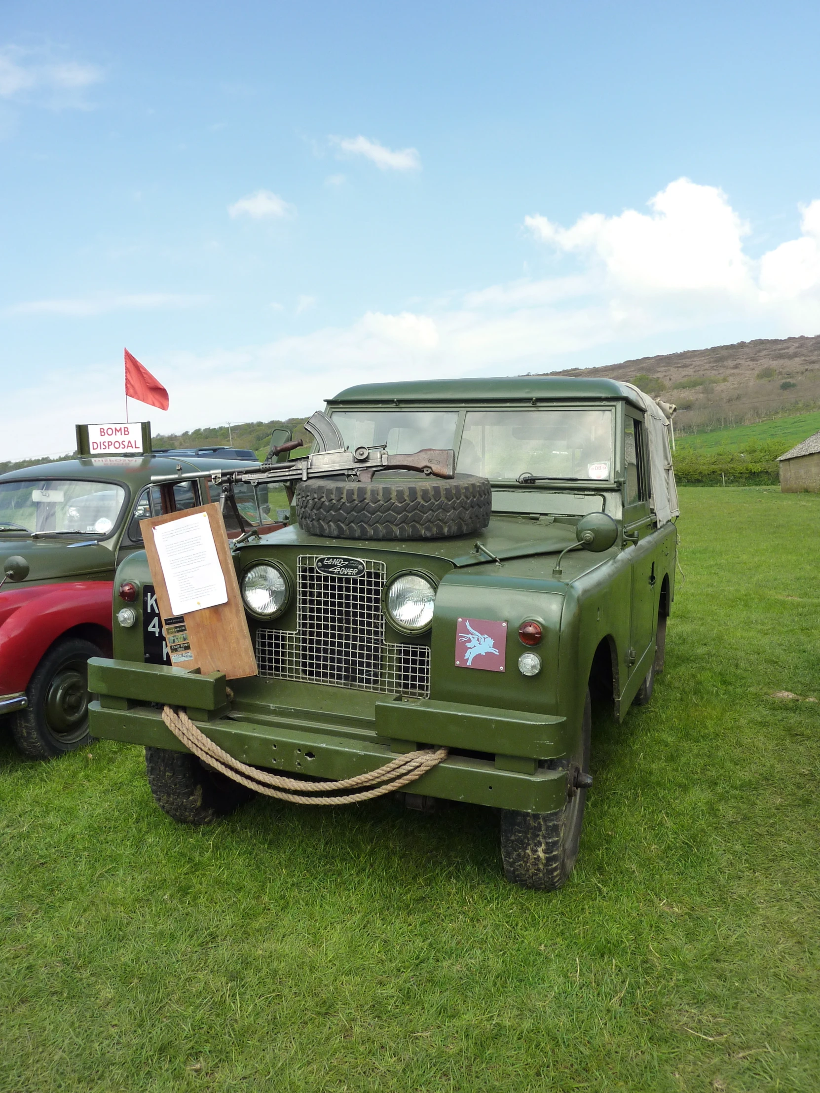 a green land rover on display at an auto show