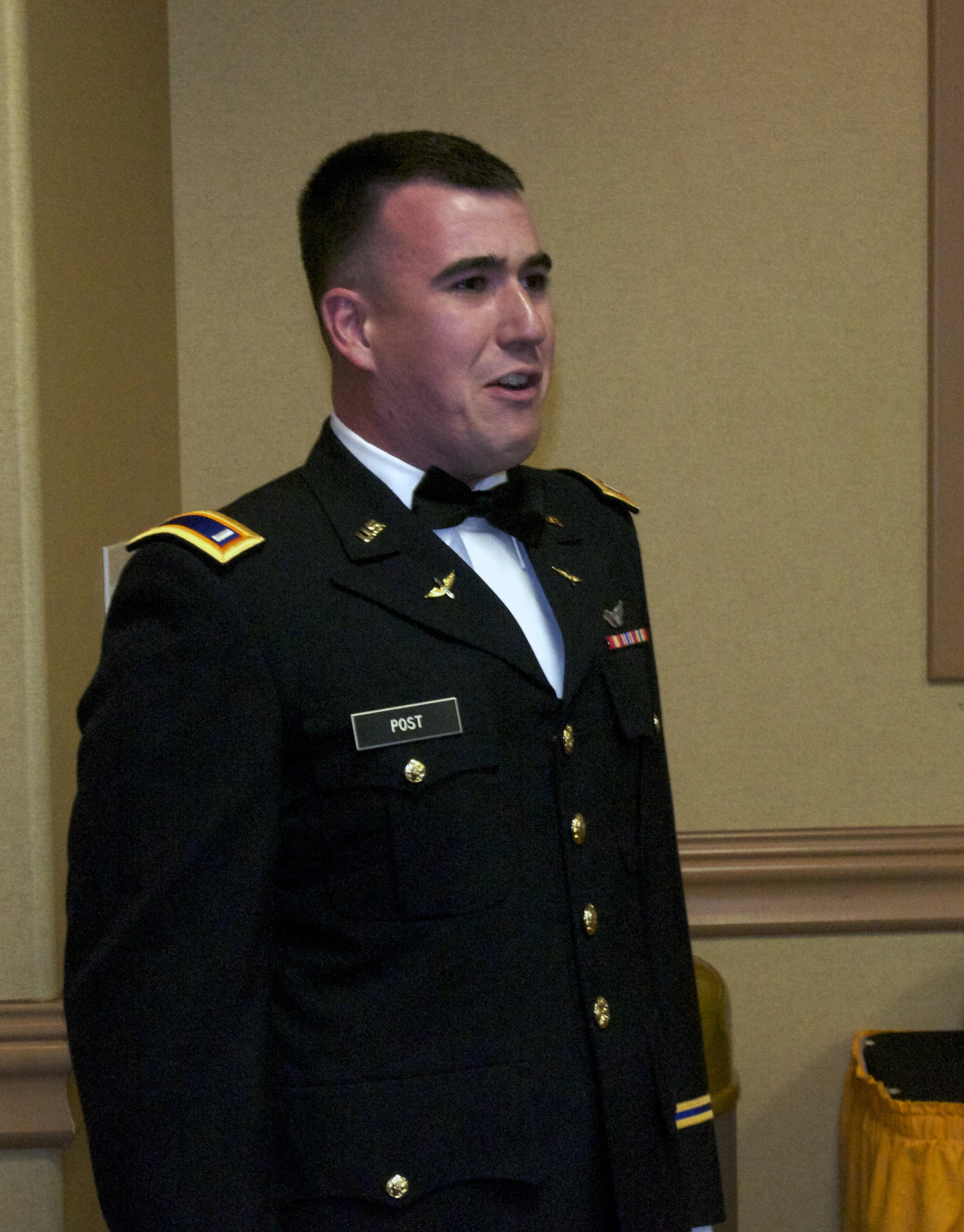 a soldier in an official dress uniform is standing