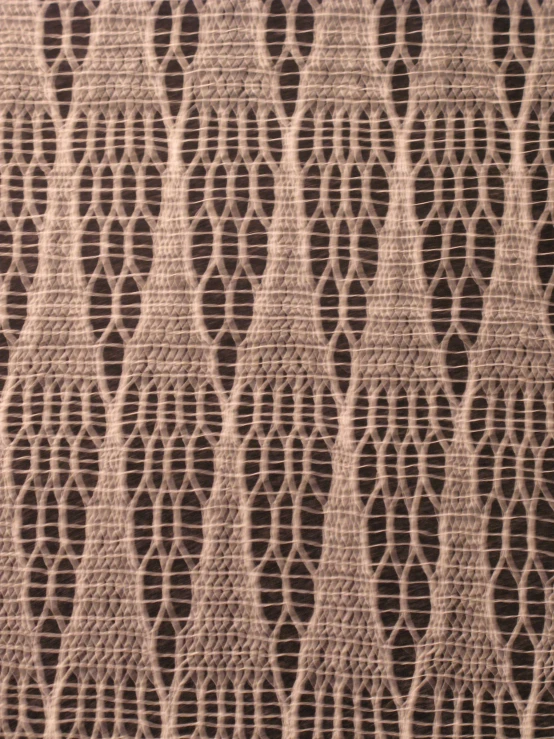 a textured fabric designed in beige with thin intersecting lines