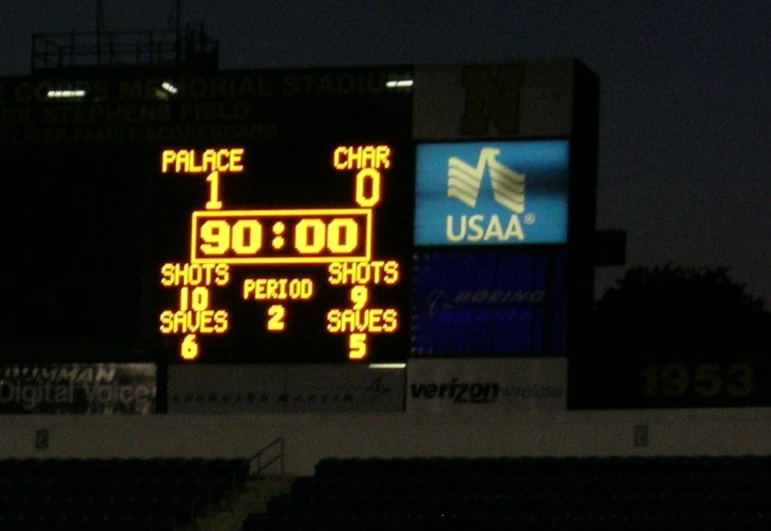 a scoreboard in front of an empty stadium