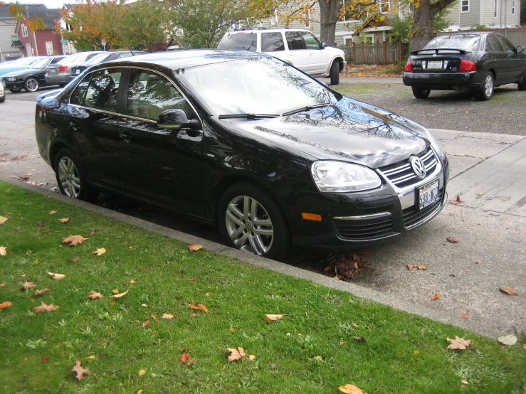 there is a small black car parked on the street