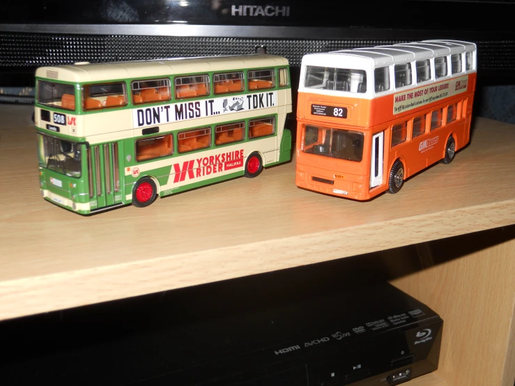 two double decker bus model sitting next to each other