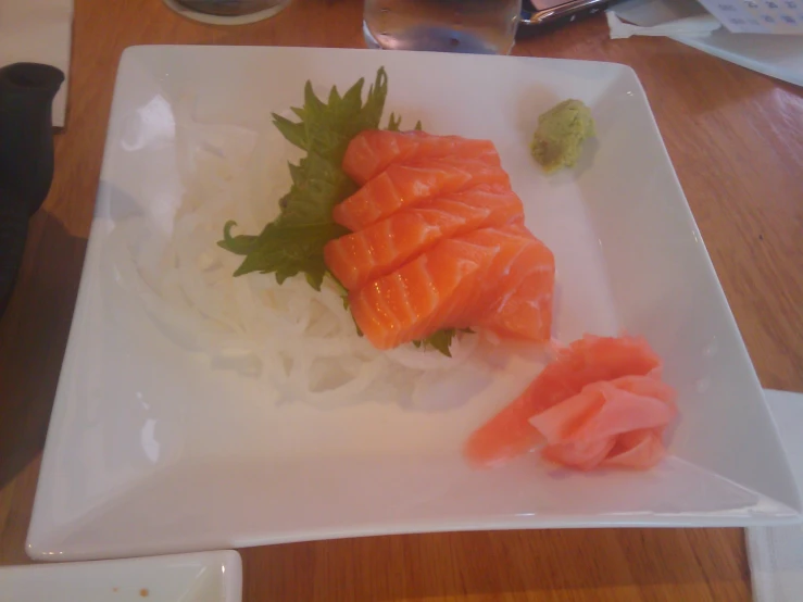 a close up of a plate of fish on rice