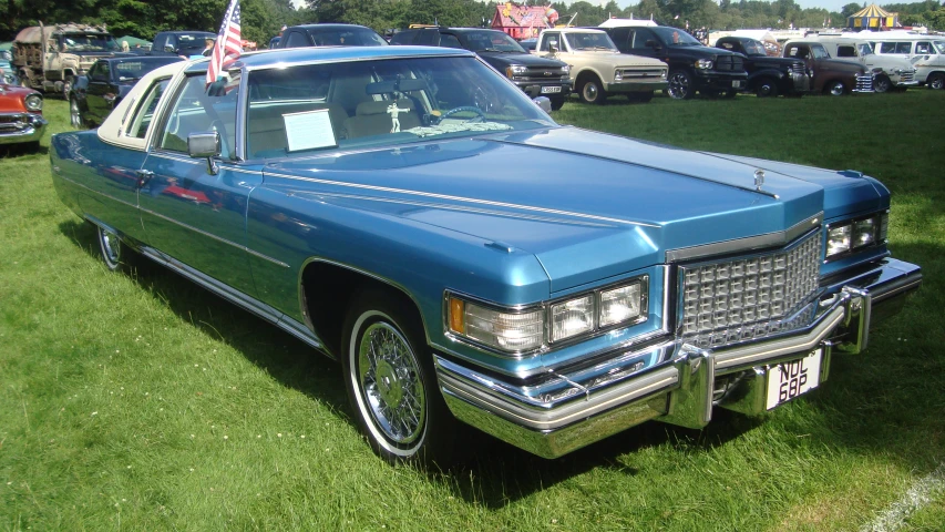 blue cadillac car with american flag in the trunk