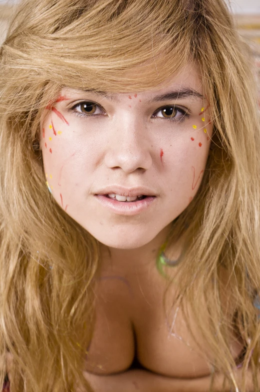 a woman has her face painted as candy