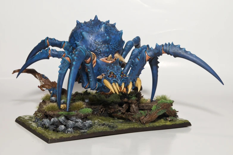 a figurine of a giant blue bug in action