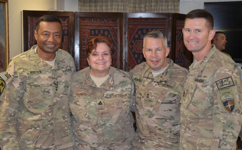 a couple of men and a woman in uniform