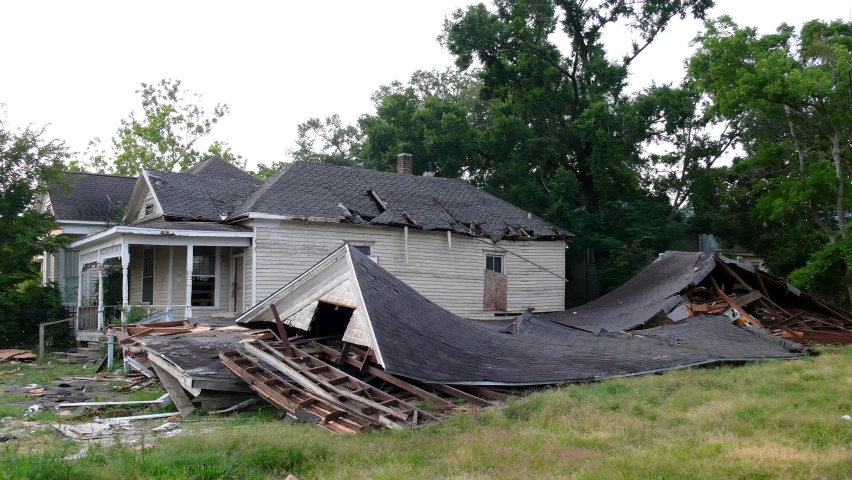 a house with a torn roof that needs to be repaired