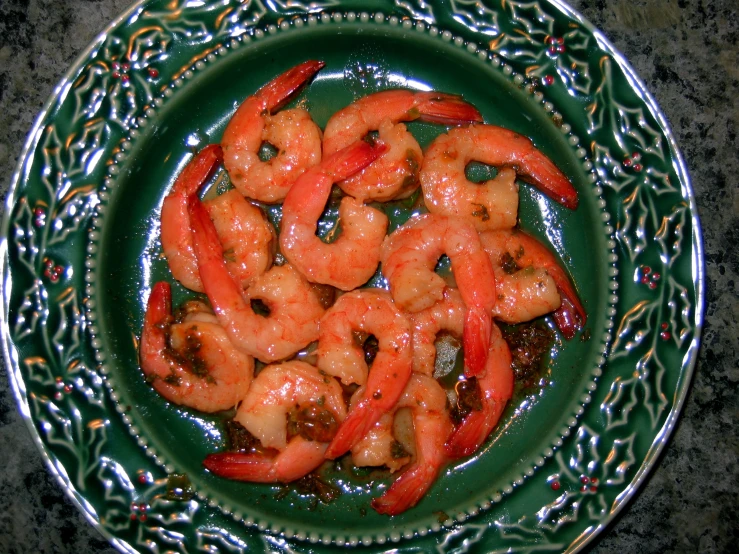 cooked raw shrimp in a green dish on a table