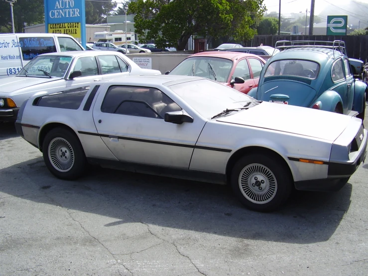 cars in a parking lot with one parked and the other facing outwards