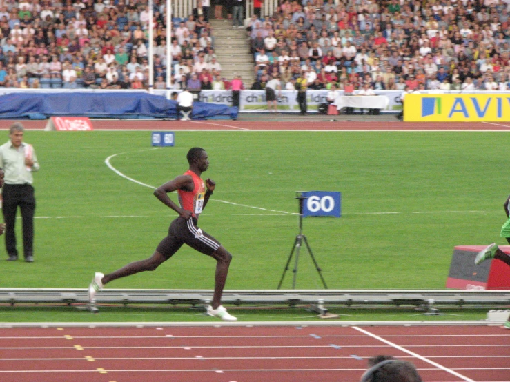 this is a woman running on the track in a stadium