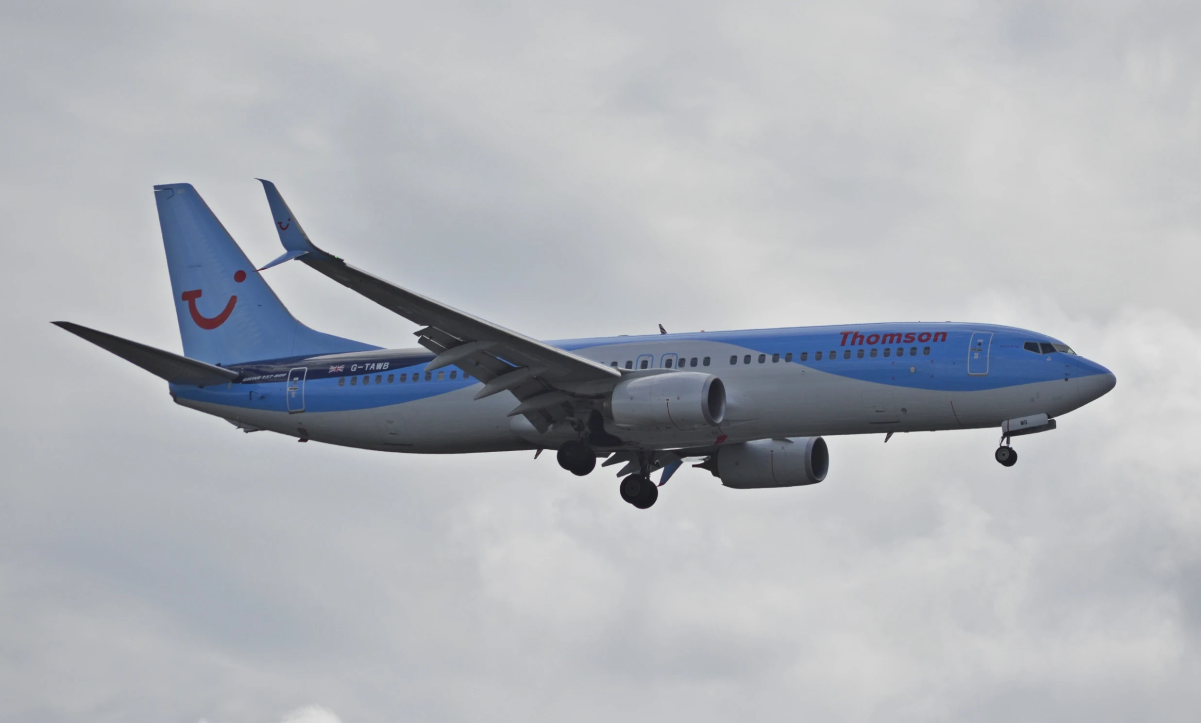 a plane with a blue tail is taking off