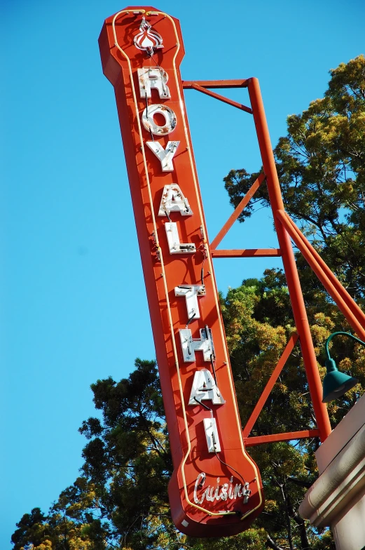 a large neon sign on top of a building