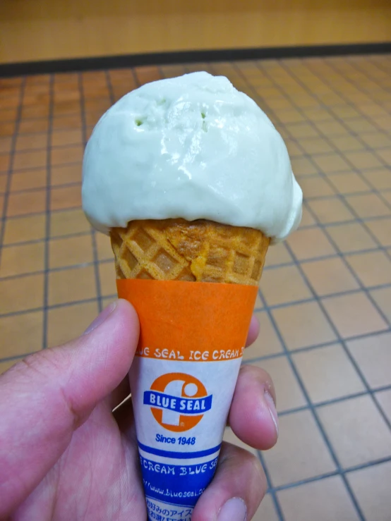 an ice cream cone in the shape of an egg is topped with whipped cream and a bite taken out of it