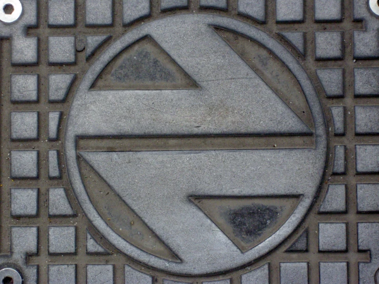 a metal sign on a tiled surface showing the letter e