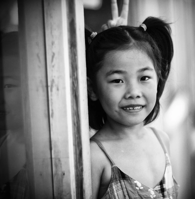 a black and white po of a little girl in an asian dress