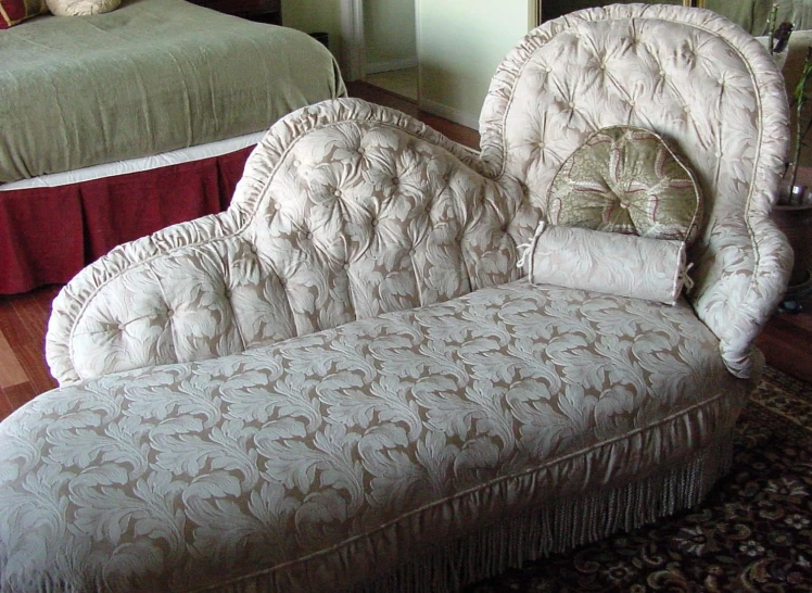 a chair with a headboard in between two beds