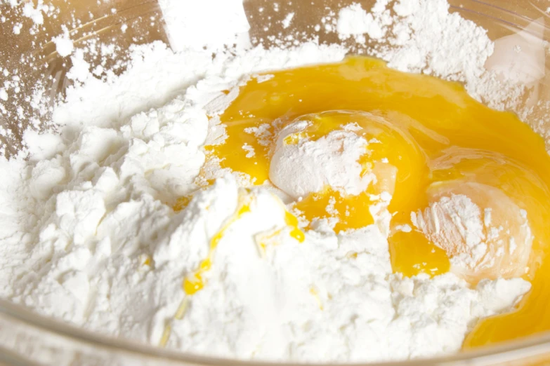 flour in bowl with yellow and white topping