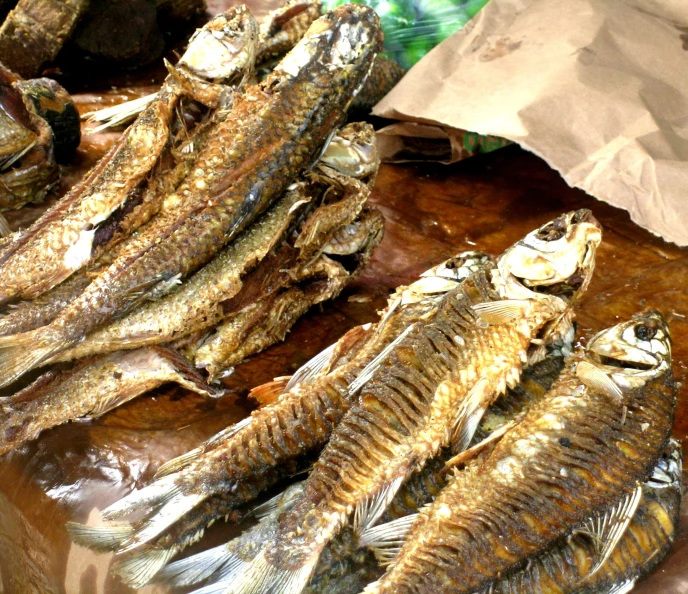 a variety of dried fish is displayed in this po