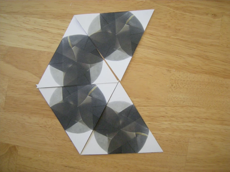 four folded folded pieces of paper on a table