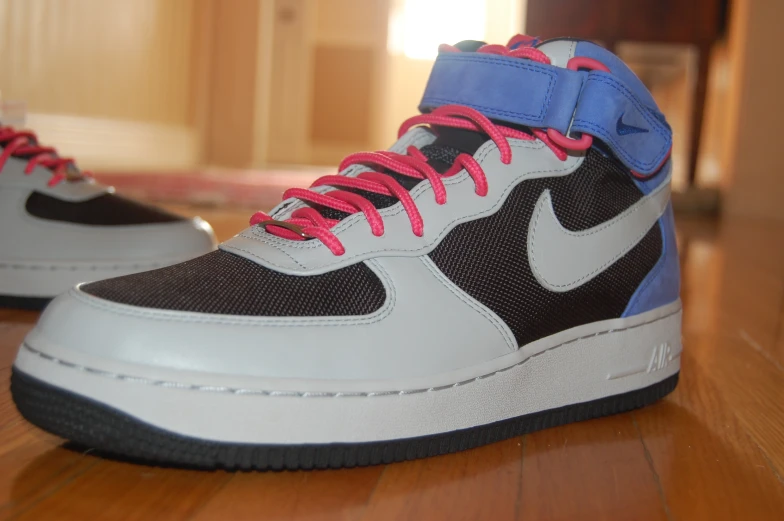 the sneaker has blue, pink, and black laces