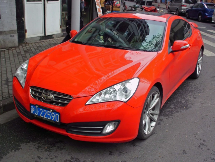 a very bright red sports car parked on a street