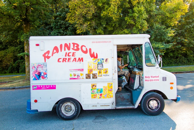 an ice cream truck is shown in the middle of the street