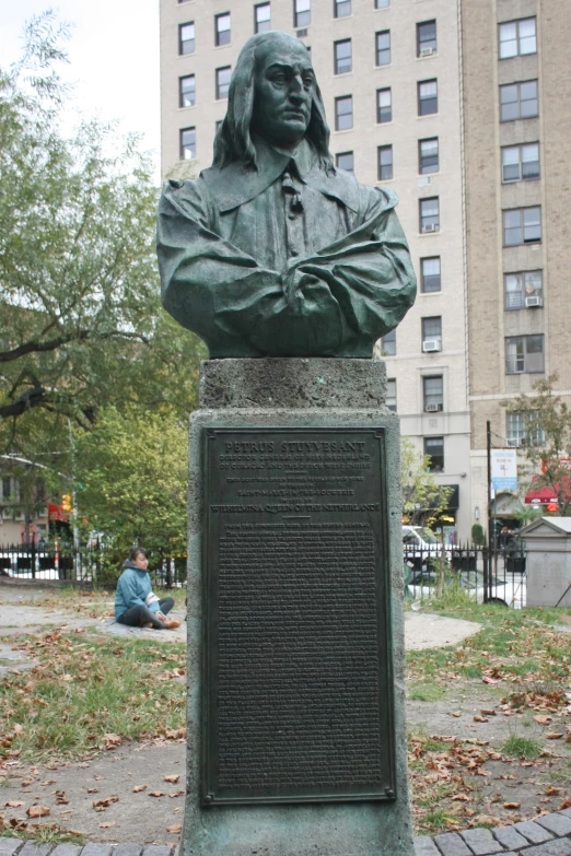 a bronze busturizer of president lincoln on a brick walkway