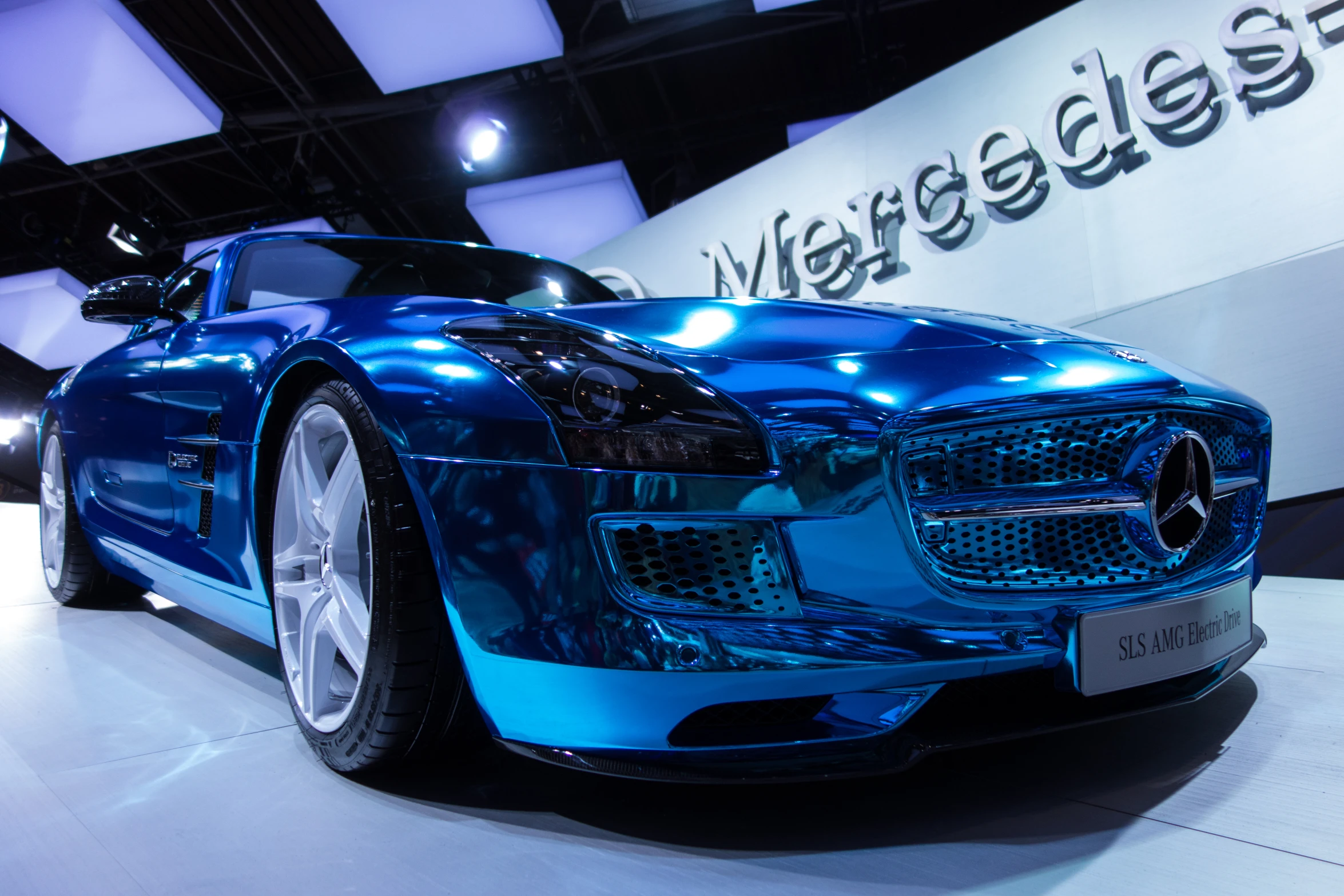 a close up of a blue sports car on display