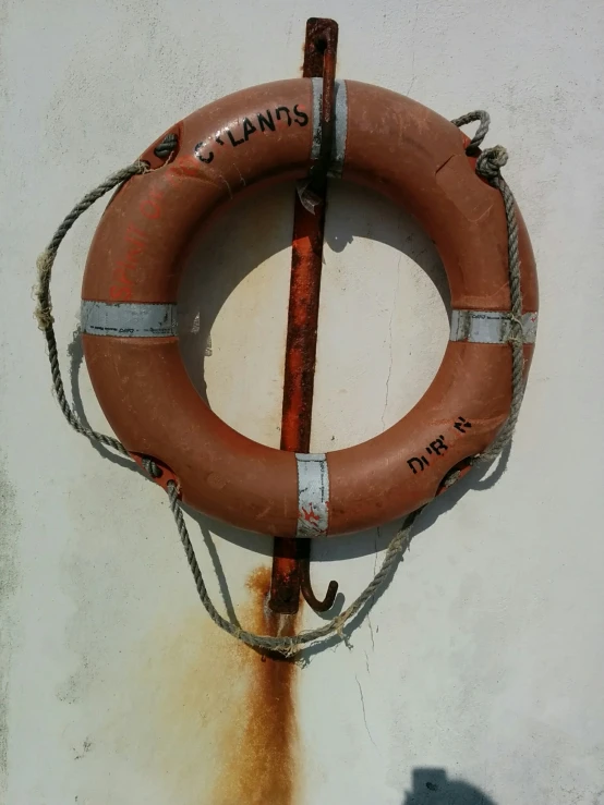 an orange life preserver hangs on the wall