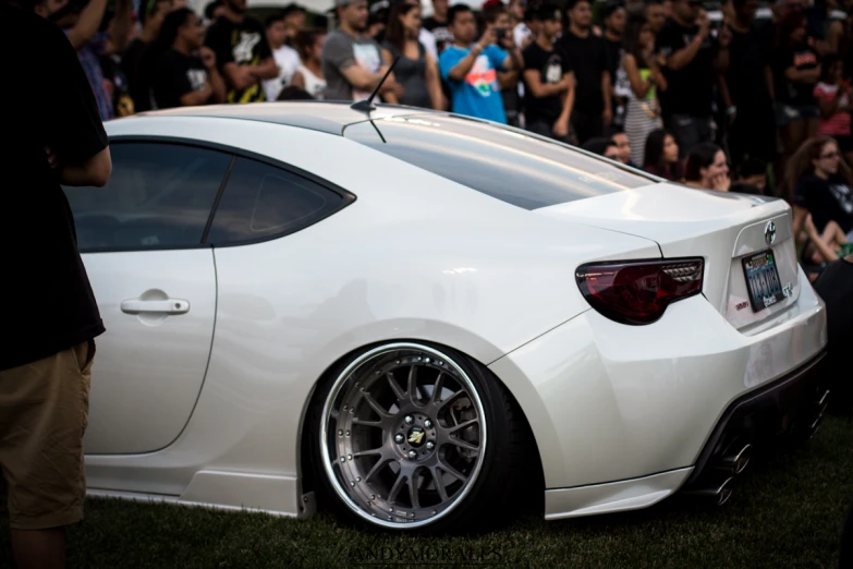 a car sitting in front of a crowd