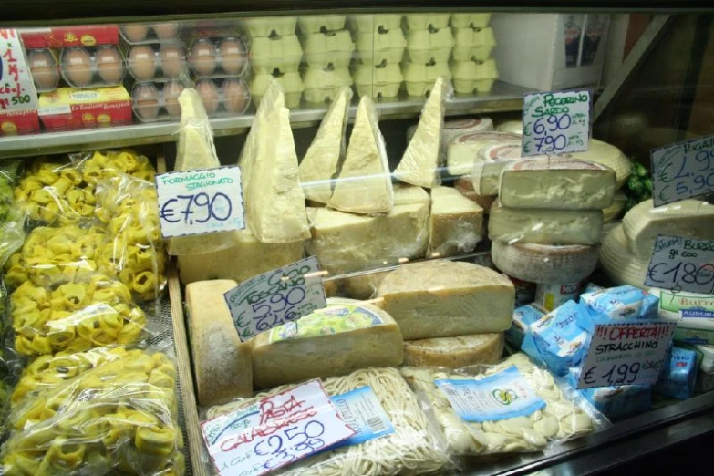 cheeses and ers are displayed in the glass case