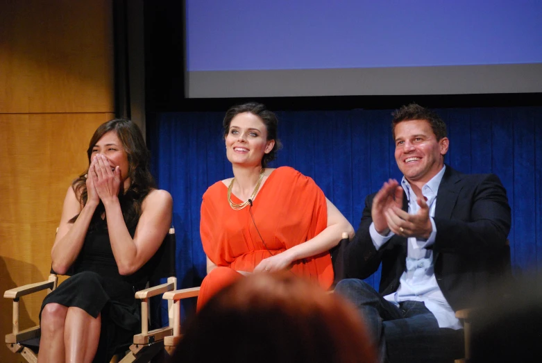 a man and a woman sitting on a stage together