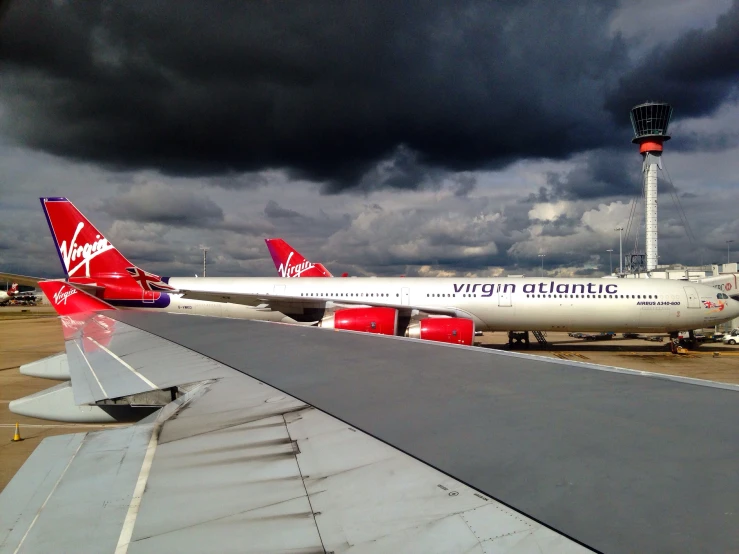 two red and white planes at an airport