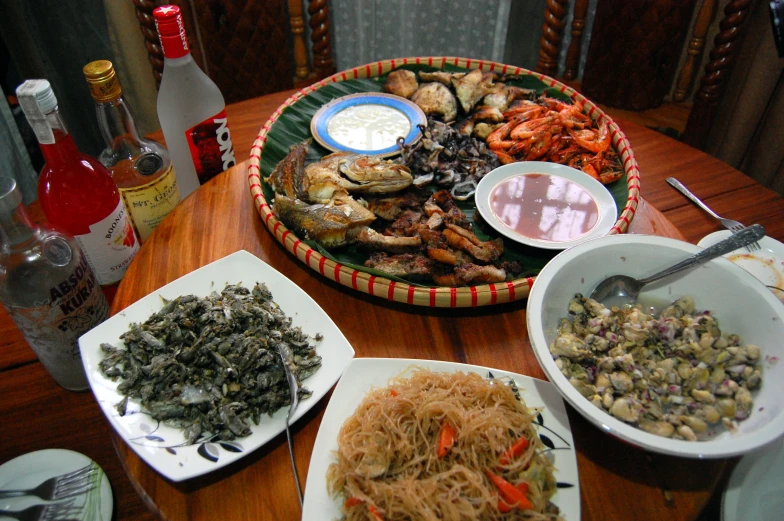 several plates and trays of food on a table