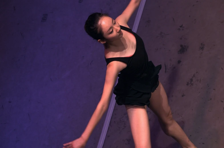 a girl is stretching in the air with her arm out