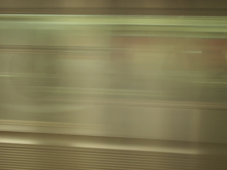 a blurry image of people sitting on a train seat