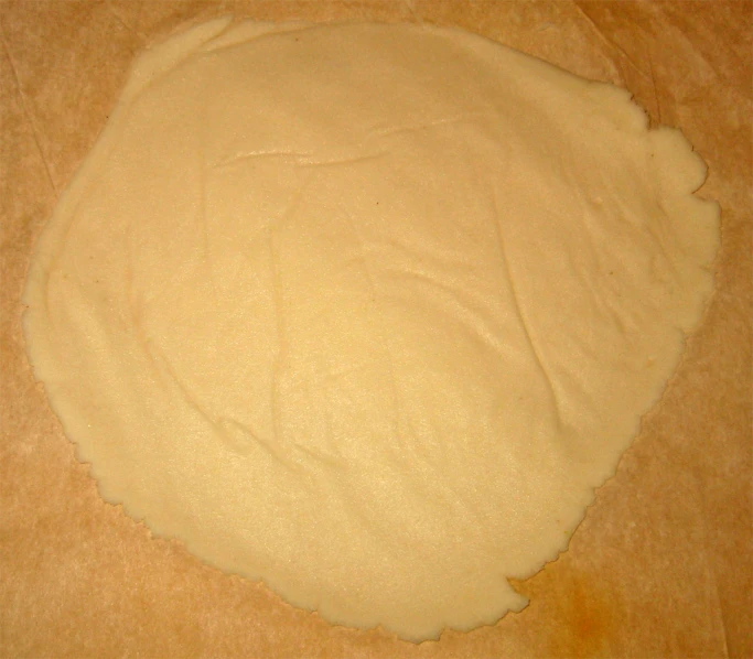 uncooked bread dough rolled in circles on counter