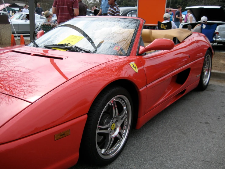 the red car is parked near many others