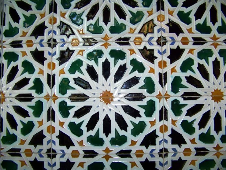 a pattern made with ceramic tiles in black, green and orange colors