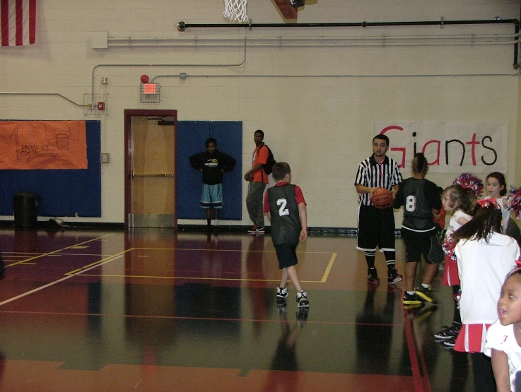 s in uniforms playing basketball on an indoor court