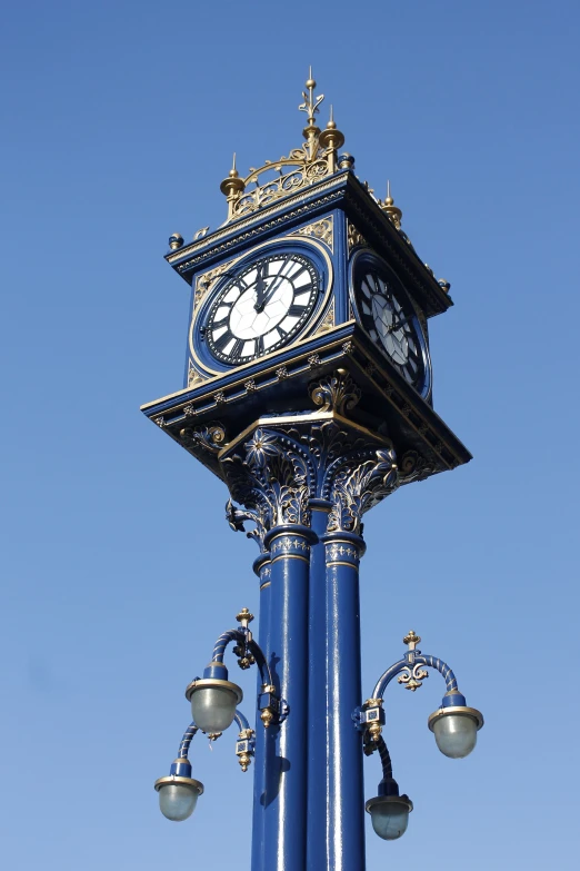 a clock tower sitting high on a street post