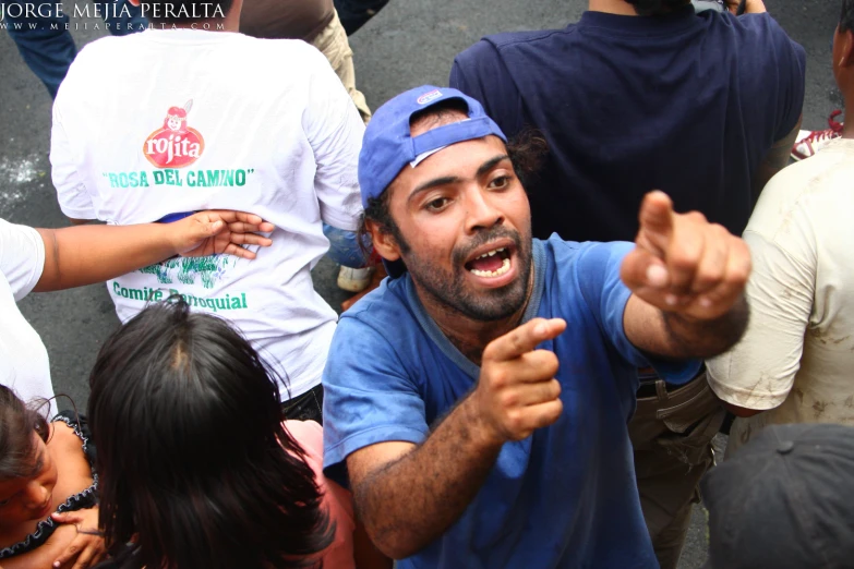 a group of people standing around an indian man pointing