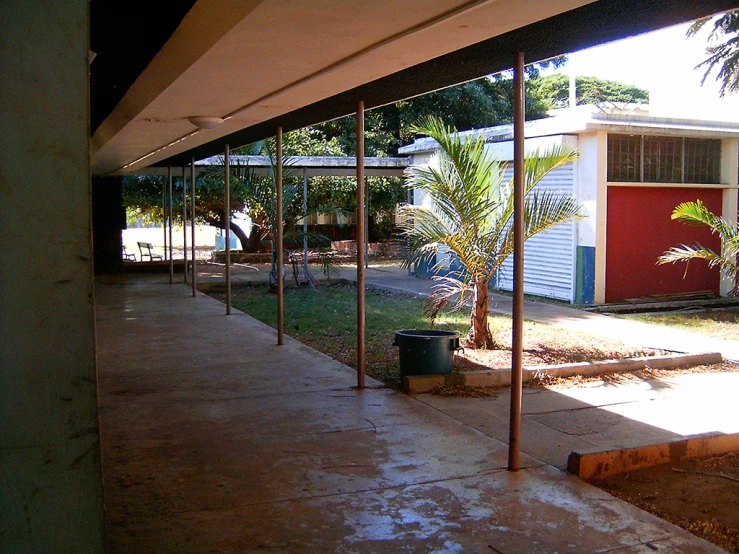 a porch and some palm trees and buildings