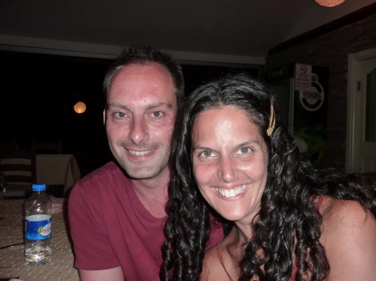 man and woman smiling for the camera inside of their home