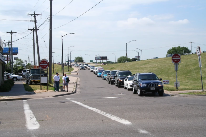 the cars are parked at the intersection where the person is standing