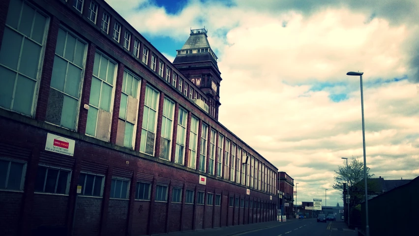 an old brick building with a clock tower next to it