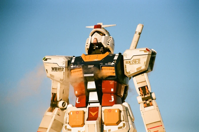 a giant mechanical robot standing in front of the sky